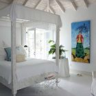 White Painted House Awesome White Painted The Coral House On Grace Bay Master Bedroom Integrating Canopy Bed With Colorful Art Architecture Luminous Private Beach House With Stylish And Chic Exotic Interiors