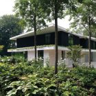 Flowers And Near Beautiful Flowers And Lust Trees Near The Villa L With Black Wall And Flat Roof Near Glass Walls Dream Homes Stunning Duplex Modern House Surrounded By Green Tree And Lawn Made From Concrete Material