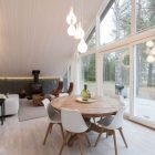 Tulips Shaped Lamp Beautiful Tulips Shaped White Pendant Lamp Above Wooden Round Desk With White Single Chairs In Chalet Lagunen Residence Dream Homes Luminous And Shining House With Contemporary Yet Balanced Color Palette