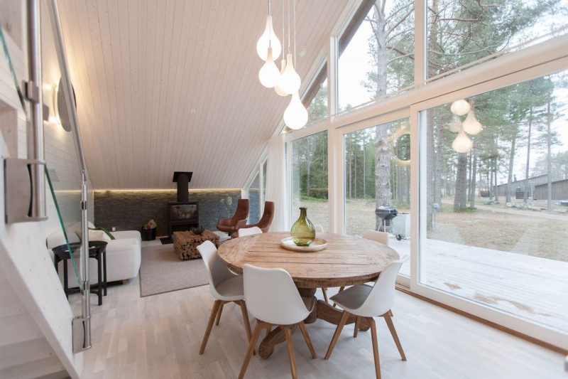 Tulips Shaped Lamp Beautiful Tulips Shaped White Pendant Lamp Above Wooden Round Desk With White Single Chairs In Chalet Lagunen Residence Dream Homes Luminous And Shining House With Contemporary Yet Balanced Color Palette