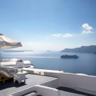 View From In Beautiful View From Katikies Hotels In Oia Deck With Loungers And Parasols Beside The Olympic Swimming Pool Interior Design Classy And Elegant White Home With Breathtaking Panoramic Sea Views