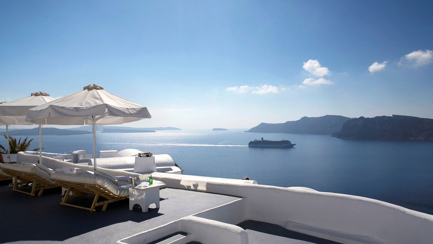 View From In Beautiful View From Katikies Hotels In Oia Deck With Loungers And Parasols Beside The Olympic Swimming Pool Interior Design Classy And Elegant White Home With Breathtaking Panoramic Sea Views