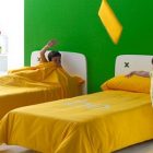 Nursery Furniture Bed Catchy Nursery Furniture With Twin Bed Couches With Lemon Yellow Bedding Set And White Racks And Cabinet Kids Room Creative Kids Bedroom Decorated With Cheerful And Playful Themes