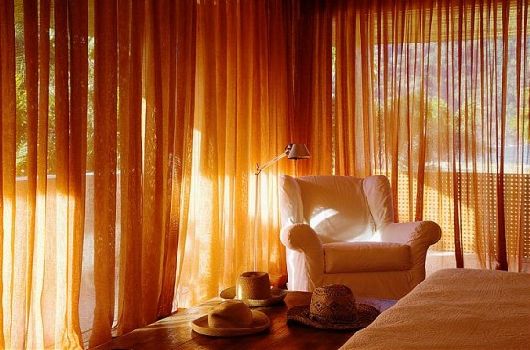 Bedroom Combined White Classy Bedroom Combined With A White Arm Chair Put At The Edge Of The Bedroom Near The Windows In Laranjeiras House By Marcio Kogan Decoration Stunning Waterfront Villa Design Surrounded By Lot Of Beautiful Trees