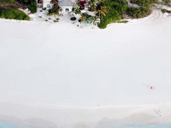 White View Sand Clear White View Of Beach Sand Found In Front Of The Coral House On Grace Bay Building With Lush Vegetation Architecture  Luminous Private Beach House With Stylish And Chic Exotic Interiors