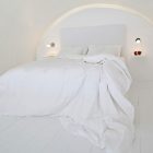 Bedroom Design Wooden Cozy Bedroom Design Applied White Wooden Floor And White Bedspread Ideas At Katikies Hotels In Oia Interior Interior Design Classy And Elegant White Home With Breathtaking Panoramic Sea Views