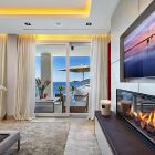 Living Room Fireplace Cozy Living Room With Modern Fireplace At Mallorca Villa Applied Hidden LED Ceiling Lamp And Metal Vase Dream Homes Luxurious Contemporary Mediterranean Villa With Sophisticated Interior Style