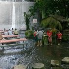 Villa Escudero Restaurant Delightful Villa Escudero Including River Restaurant With Wooden Table And Bench With Waterfall And Forrest Views In A Fresh Atmosphere Restaurant Unique Villa Design Providing Stunning Unusual Experience