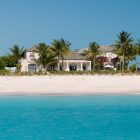 Catching White House Eye Catching White The Coral House On Grace Bay Building Seen From Sea With White Sandy Ground And Palm Trees Architecture Luminous Private Beach House With Stylish And Chic Exotic Interiors