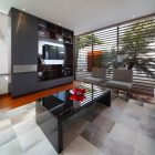 Tv Room Residence Fascinating TV Room In Patio Residence With Wooden Shelves And Dark Table Near Grey Sofa On Grey Carpet Dream Homes Stunning White Home With Authentic Patio In Modern Style