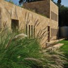Grassy Yard Plants Freshening Grassy Yard And Ornamental Plants At Fidar Beach House In Modern Architecture Tough Stone Outdoor Wall Dream Homes Futuristic Modern Beach House With Neutral Color Palettes For A Family Of Five