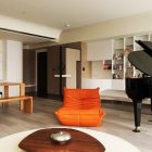 Orange Chair Couple Interesting Orange Chair Placed To Couple Round Wooden Table Inside Apartment Unitary Room With Grand Piano Apartments Delightful Simple Interior Design In Neutral Palette And Vivid Furniture