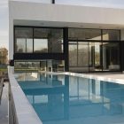 Outdoor Living Of Interesting Outdoor Living Space Design Of Grand Bell Residence With Grey Colored Partition And Big Swimming Pool With Blue Colored Water Dream Homes Fresh White Home Shades Of Clean And Airy Interior Ideas