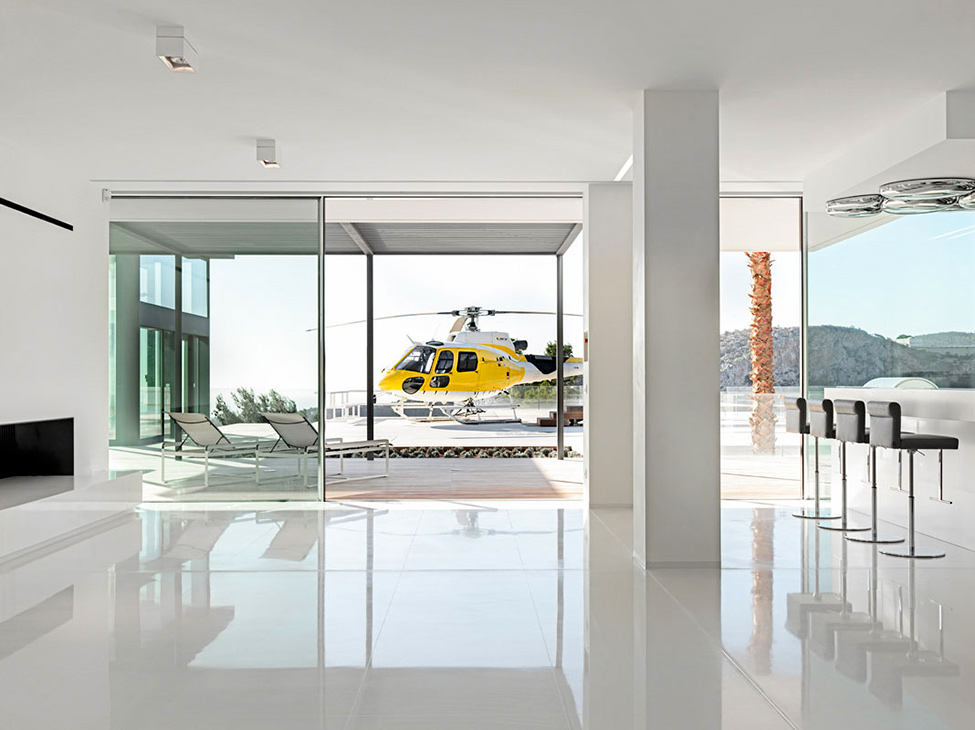 Helicopter Landing With Lavish Helicopter Landing Area Design With Transparent Sliding Door Made From Glass Panels And Several White Sleeper Chairs Hotels & Resorts Fabulous Modern Villa In Spain With White Living Room Appearance