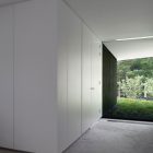 Alleyway Of L Minimalist Alleyway Of The Villa L With White Door And White Ceiling Above The Grey Floor Dream Homes Stunning Duplex Modern House Surrounded By Green Tree And Lawn Made From Concrete Material