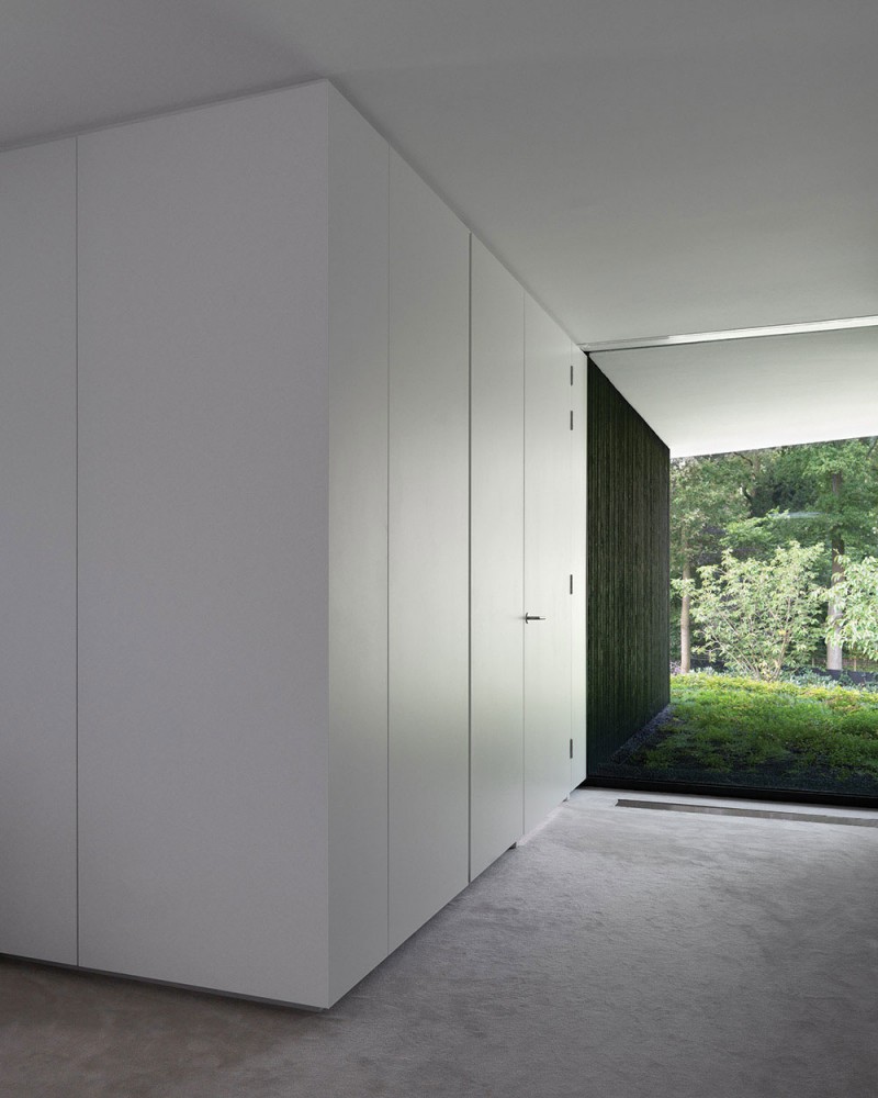 Alleyway Of L Minimalist Alleyway Of The Villa L With White Door And White Ceiling Above The Grey Floor Dream Homes Stunning Duplex Modern House Surrounded By Green Tree And Lawn Made From Concrete Material