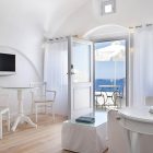 Design Of At Modern Design Of Family Room At Katikies Hotels In Oia With Glass Top Table And White Transparent Curtain Design Interior Design Classy And Elegant White Home With Breathtaking Panoramic Sea Views