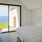 White Bed Chairs Modern White Bed Red Acrylic Chairs Glass Door In Dark Frame Concrete Floor Appealing Beach View Fidar Beach House Dream Homes Futuristic Modern Beach House With Neutral Color Palettes For A Family Of Five