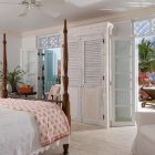 The Coral Grace Open The Coral House On Grace Bay Bedroom Idea Involving Four Poster Bed Idea Coupled With Skirted Chair Architecture Luminous Private Beach House With Stylish And Chic Exotic Interiors