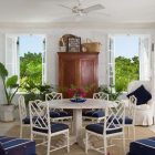 The Coral Grace Stylish The Coral House On Grace Bay Dining Room Idea Furnished With Navy Chairs Surrounding Round Table Architecture Luminous Private Beach House With Stylish And Chic Exotic Interiors