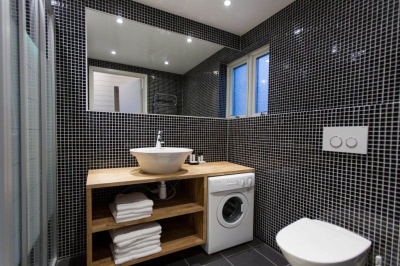 White Black Of Terrific White Black Tiled Wall Of Bathroom In Chalet Lagunen Residence Completed With Washing Machine And Wooden Open Cabinets Dream Homes  Luminous And Shining House With Contemporary Yet Balanced Color Palette