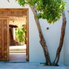 Wooden Doors Wall Traditional Wooden Doors And White Wall In The Villas Suluwilo By Studio COA Facade With Green Tree Decoration Wonderful Modern Villa With Gorgeous Inner Courtyards And Open Living Space