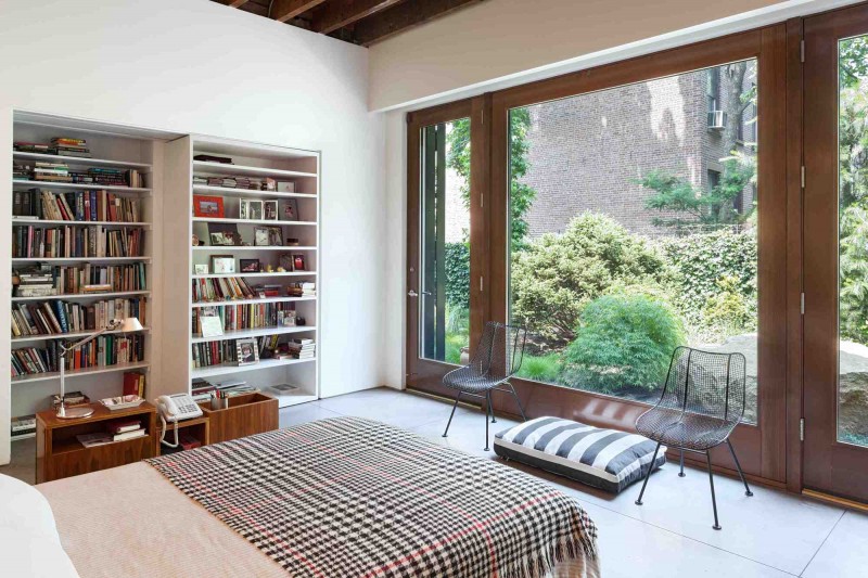 White Bookshelves Door Unique White Bookshelves As The Door In The Brooklyn Studio Bedroom With Wooden Nightstand And Iron Chairs Interior Design  Enchanting Home Ideas With Dual Interior Design Full Of Personality