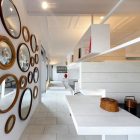 Rounded Mirrors White Unusual Rounded Mirrors On The White Wall In Ceramic House Madrid Spain With White Floor And White Bookshelves Interior Design Elegant Ceramic Interior Design With Beautiful Dining And Kitchen Partition