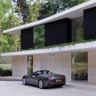 Open Parking The Wide Open Parking Space Outside The Villa L With Wide Glass Walls And Brown Wall Under Black Walls Dream Homes Stunning Duplex Modern House Surrounded By Green Tree And Lawn Made From Concrete Material