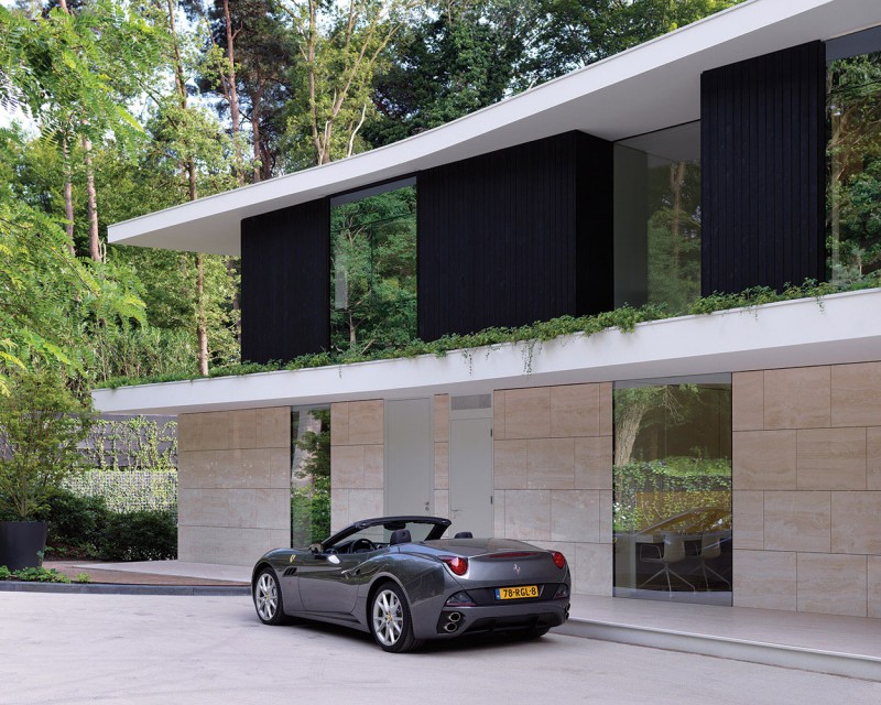 Open Parking The Wide Open Parking Space Outside The Villa L With Wide Glass Walls And Brown Wall Under Black Walls Dream Homes Stunning Duplex Modern House Surrounded By Green Tree And Lawn Made From Concrete Material