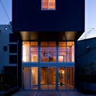 Front Yard Of Amazing Front Yard Entrance Design Of House In Waga Zaimokura With Soft Grey Color Marble Floor And Bright Orange Lighting From Inside Dream Homes Stunning Cantilevered House With Sophisticated And Natural Wooden Interiors