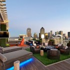 Outdoor Patio Brown Comfort Outdoor Patio Design With Brown Lounges Facing Black Chairs Feat Green Carpet In Balcony Area Interior Design Colorful Neon Interior Paint With Contemporary Interior Accents