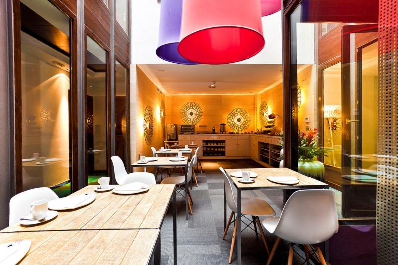 Dinning Table Wodoen Complete Dinning Table Design With Wooden Table Under Pendant Lamps In Hotel Portago Urban And Glass Wall Finished Decor Hotels & Resorts Bright Modern Interiors With Vibrant Pops Of Colors For Hotels