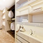 Spacious Closet White Glamorous Spacious Closet With Minimalist White Cabinet And Shelves Stainless Steel Railing Sleek White Marble Floor Shiny LED Light Dream Homes Extravagant Luxurious Interior Decoration Brings Warm And Cozy Nuance