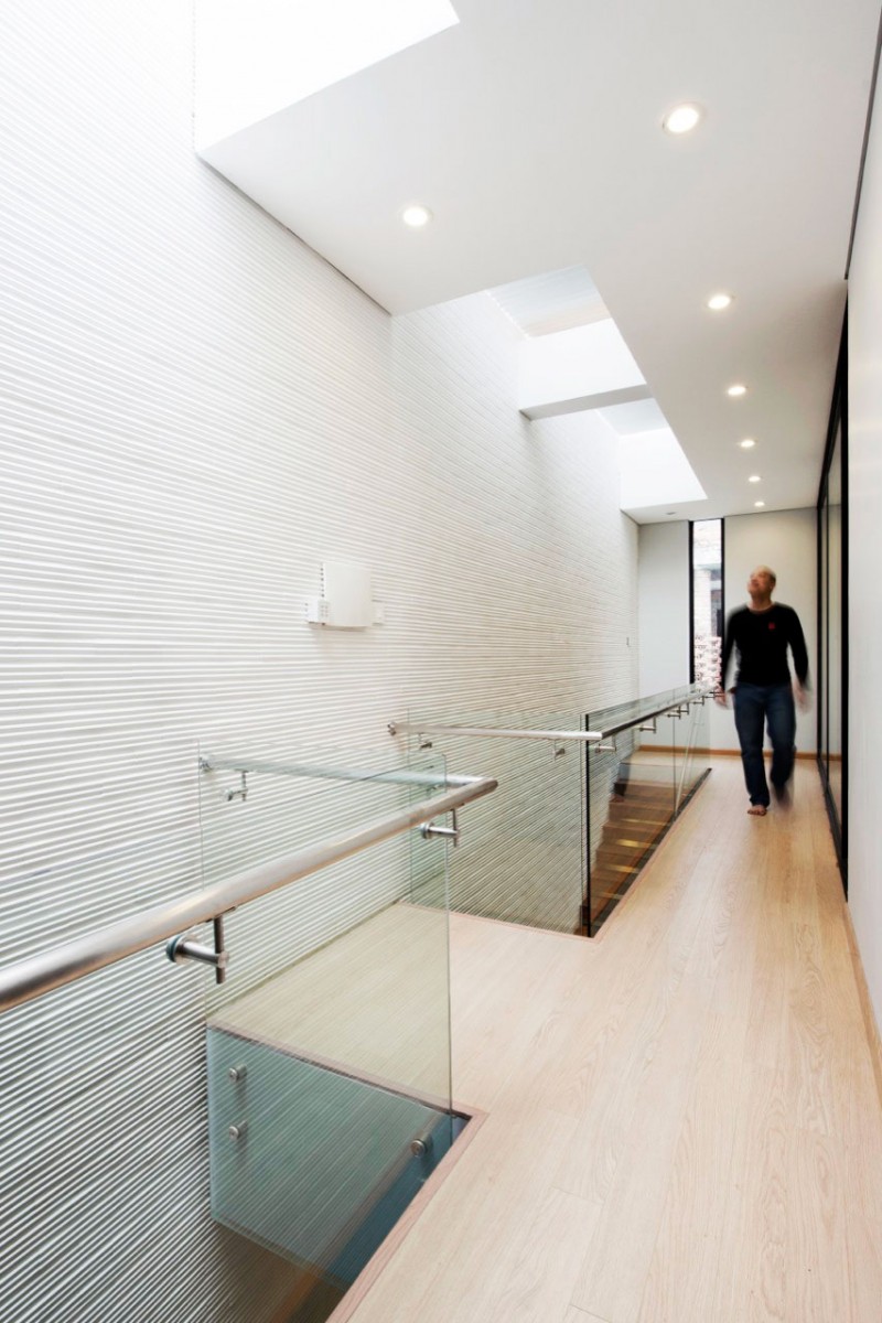 White Striped Empty Marvelous White Striped Wall In Empty Space In The 45x20 House Completed With Glass Railing Around It Installed In Wooden Floor Dream Homes Remarkable Modern Home With Bright Color Schemes For A Young Family With One Children