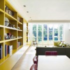 Yellow Books The Terrific Yellow Bookshelves On The White Painted Wall Inside Chevron Residence Installed Near White Dining Desk With Tufted Single Chairs Dream Homes Elegant And Vibrant Interior Design For Stunning Creative Brick House