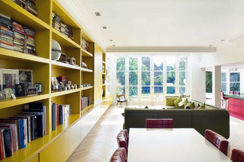 Yellow Books The Terrific Yellow Bookshelves On The White Painted Wall Inside Chevron Residence Installed Near White Dining Desk With Tufted Single Chairs Interior Design  Elegant And Vibrant Interior Design For Stunning Creative Brick House