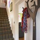 Entry With Artistic Amazing Entry With Striped Staircase Artistic Painting Innovative Tree Shaped Used Coat Racks Lacquered Wood Floor Dark Sofa Decoration Chic And Classy Coat Racks Brimming With Elegant Interior Decorations