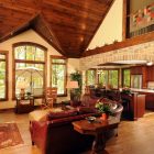 Rustic Living With Amazing Rustic Living Room Interior With Brown Curved Leather Sectional Sofas Completed With Cream Ottoman Decoration Glamorous Leather Sectional Sofas Display Classy Room Themes