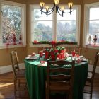 Christmas Dinner In Classic Christmas Dinner Table Decorations In Fancy Dining Room Glass Bay Window Green Tablecloth Rustic Wood Chairs Dining Room Easy Christmas Dinner Table Decorations With Luxurious Colors Combinations