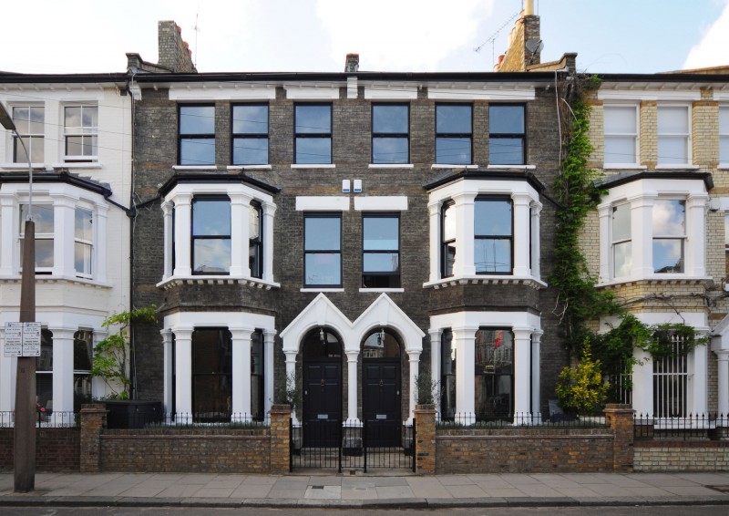 House With Wall Classic House With Rustic Stone Wall Glass Bay Window Dark Metallic Fence Ornamental Plants Arched Door Dream Homes Elegant Black And White House In London By Bureau De Change Design Office