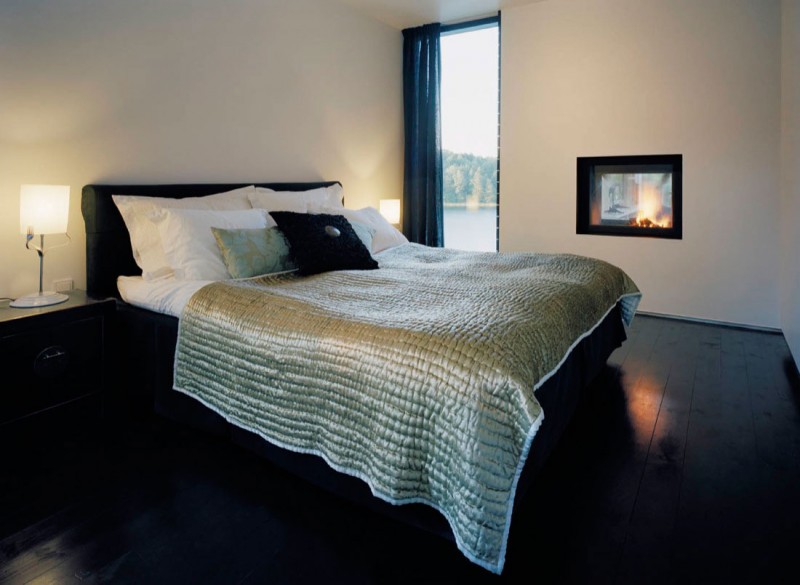 Bed With Quilt Cozy Bed With Silver Tufted Quilt And Box Bedside Tables In Modern Casa Barone Stylish Gas Fireplace Soft Nightlights Dream Homes Elegant Lakeside House Surrounded With Fresh Nature Landscape