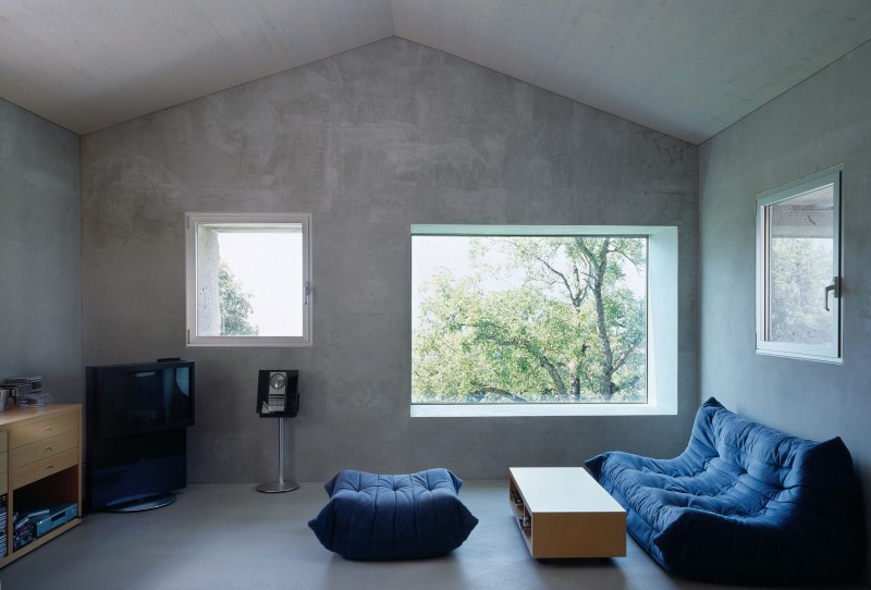 Dark Tufted Box Cushy Dark Tufted Sofa And Box Wood Coffee Table Sleek Concrete Floor Square Glass Windows In Chamoson House Dream Homes Unusual Contemporary Rural House With Rough Stone Wall Structure