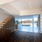 Wood Staircase Light Enchanting Wood Staircase Bright Ceiling Light Wood Floor White Wall Shelves Glass Wall Contemporary White Kitchen Island Dream Homes Elegant Black And White House In London By Bureau De Change Design Office