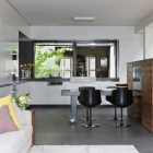 Fitzroy House Dark Great Fitzroy House With Glossy Dark Chairs Surrounding Concrete Kitchen Island Colorful Pillows On White Sofa Kitchen Cabinet Dream Homes Bright Contemporary House With Open Plan Living Room Spaces