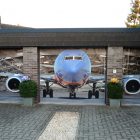 Garage Door Displaying Great Garage Door Decals Idea Displaying Huge Air Plane Parked Inside The Garage With Three Garage Door Panels Decoration Creative Garage Door Covers And Decals To Style Your Artistic Garage Door