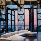 Living Room Glass Industrial Living Room With Swing Glass Door Modern White Sectional Big Sofas Sleek Dark Floor Tile Tough Metallic Roof Truss Dream Homes Elegant Big Sofas Makes Your Living Lounge Look Expensive