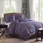 Wrinkled Purple On Lavish Wrinkled Purple Duvet Cover On Modern Bed With Padded Bed Headboard Sheer White Drape Shiny Table Lamp On Dark Wood Bedside Table Bedroom Comfortable Purple Duvet Covers For Your Beautiful Bedroom Sets