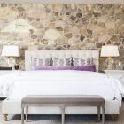 Stone Bed Modern Rough Stone Bed Headboard In Modern Bedroom With White Duvet Cover Appealing Carpet Padded Bench Shiny Table Lamps On White Bedside Tables Bedroom Natural White Duvet Cover For Simple Contemporary Bedrooms