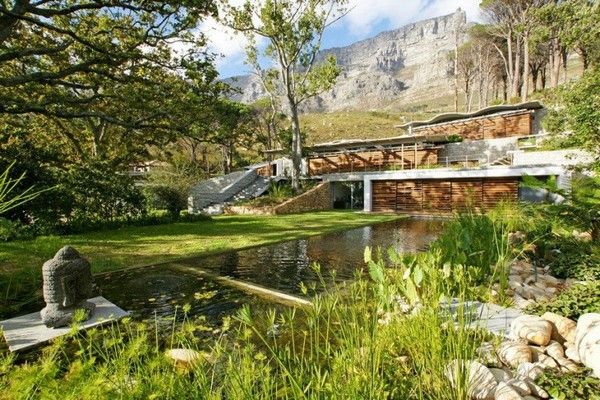 Long Pond Beautiful Wonderful Long Pond Outside The Beautiful Home Near The Green Grass Yard And Some Green Trees  Breathtaking Mountain House Blends In With Fresh Landscape Environment